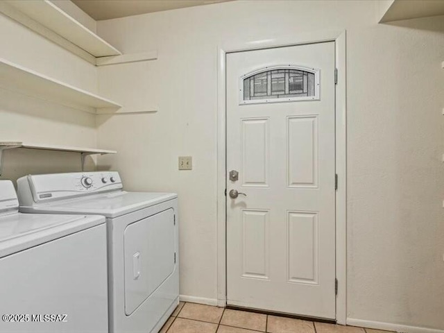 washroom with light tile patterned flooring and washer and clothes dryer