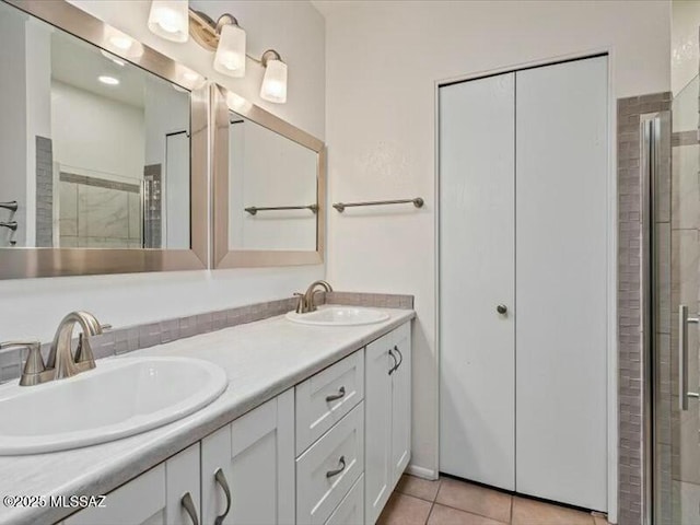 bathroom with tile patterned flooring, vanity, and a shower with shower door