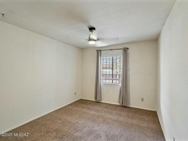 empty room featuring a textured ceiling and carpet