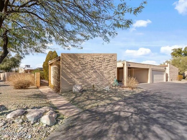 pueblo-style home featuring a garage