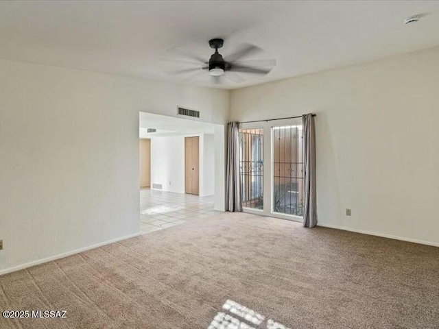 empty room featuring light carpet and ceiling fan