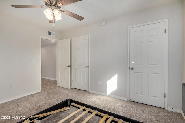 unfurnished bedroom featuring carpet and ceiling fan