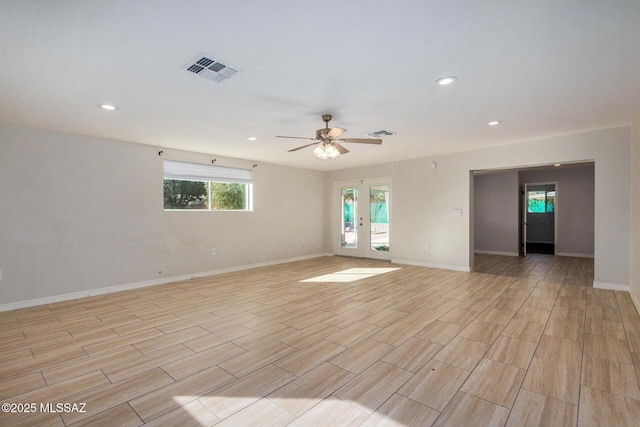 spare room featuring ceiling fan and french doors