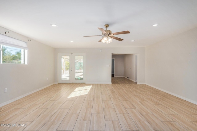 spare room featuring french doors and ceiling fan