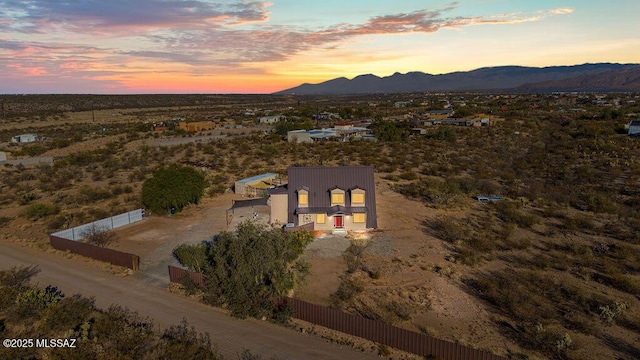 aerial view at dusk featuring a mountain view