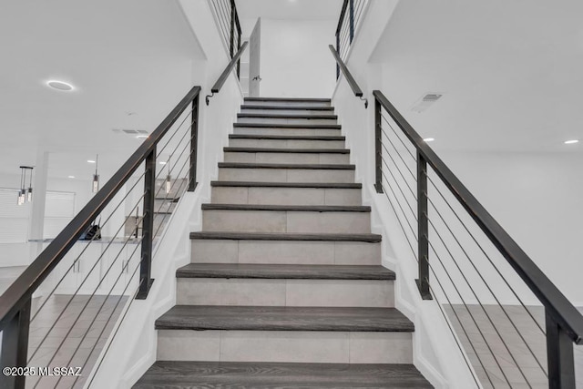 stairs with hardwood / wood-style floors