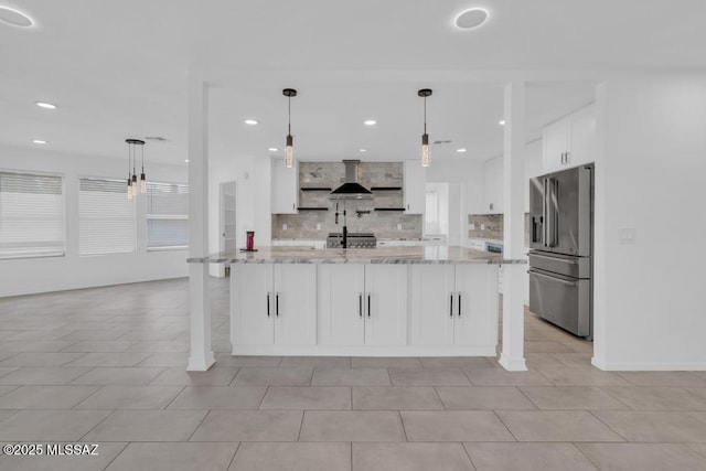 kitchen with high end fridge, light stone counters, pendant lighting, decorative backsplash, and white cabinets