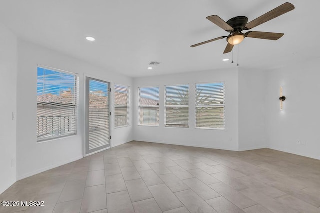 unfurnished sunroom with ceiling fan