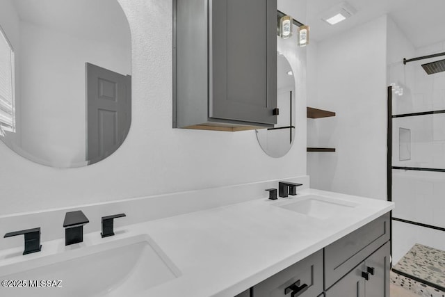 bathroom featuring vanity and tiled shower