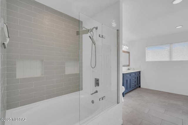 full bathroom featuring enclosed tub / shower combo, vanity, and toilet