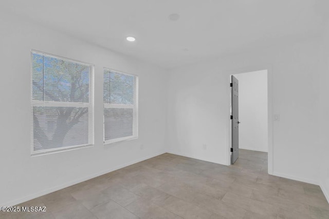 unfurnished room featuring plenty of natural light