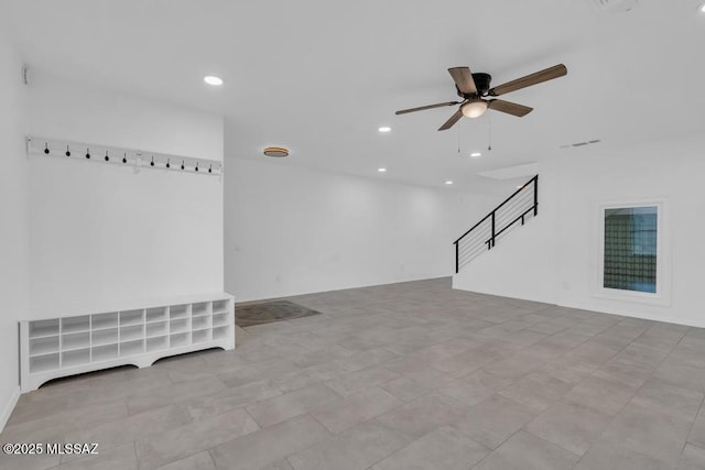 unfurnished living room with ceiling fan