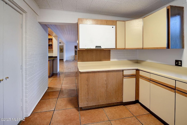 kitchen featuring light countertops, cream cabinets, and light tile patterned floors