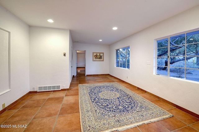 tiled spare room featuring recessed lighting, visible vents, and baseboards