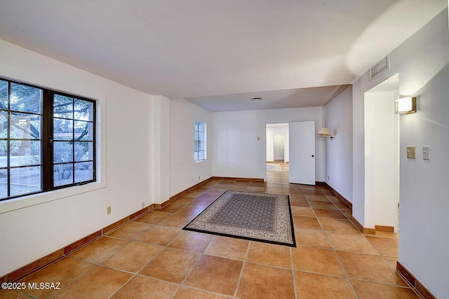 foyer entrance with plenty of natural light, visible vents, and baseboards