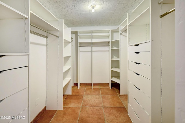 walk in closet with light tile patterned flooring