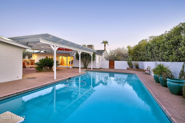 view of swimming pool with a fenced in pool, fence, a patio, and a pergola