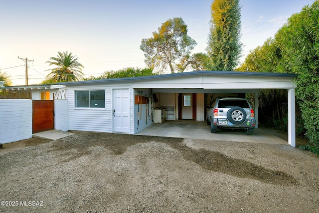 garage with a carport and driveway