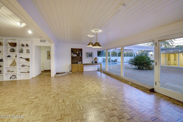 unfurnished sunroom with wooden ceiling, visible vents, and a healthy amount of sunlight