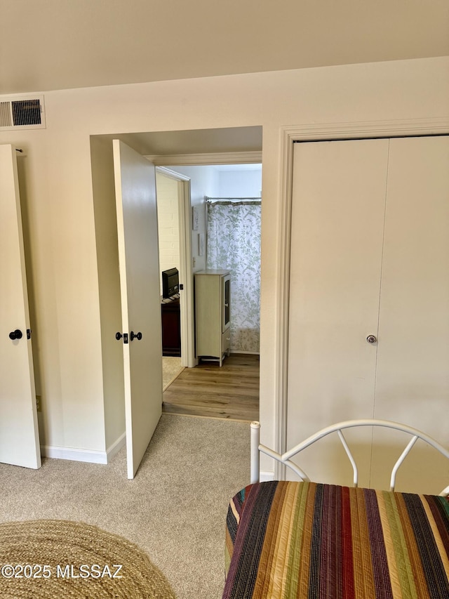 unfurnished bedroom featuring a closet, visible vents, and carpet