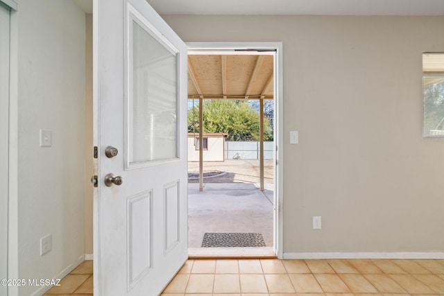 foyer featuring a wealth of natural light and light tile patterned flooring