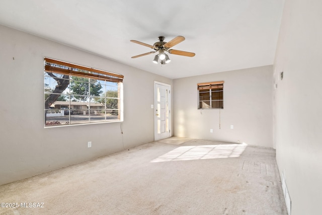 empty room with light colored carpet and ceiling fan