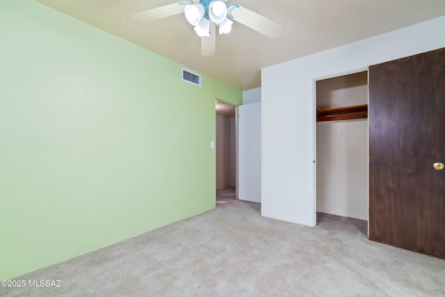 unfurnished bedroom with light carpet, a closet, and ceiling fan