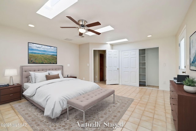 tiled bedroom with a closet, ceiling fan, and a skylight