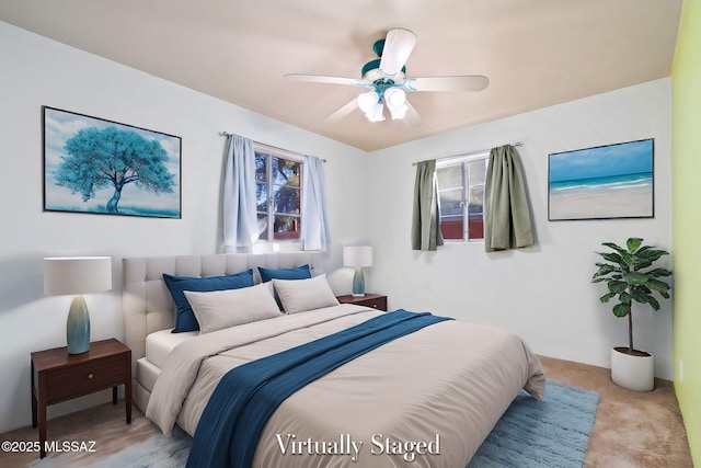 bedroom featuring ceiling fan and light carpet