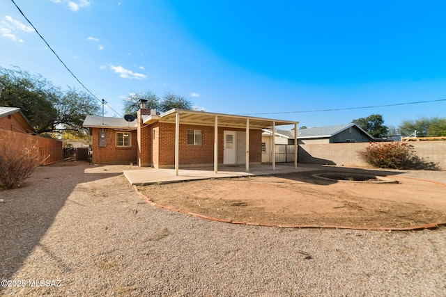 rear view of house with central AC unit and a patio area