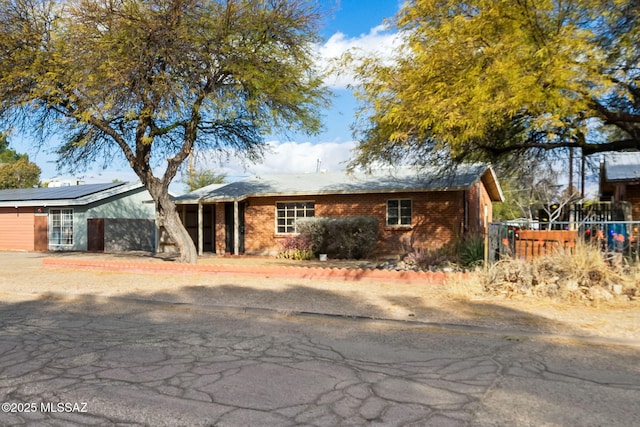 ranch-style house with solar panels