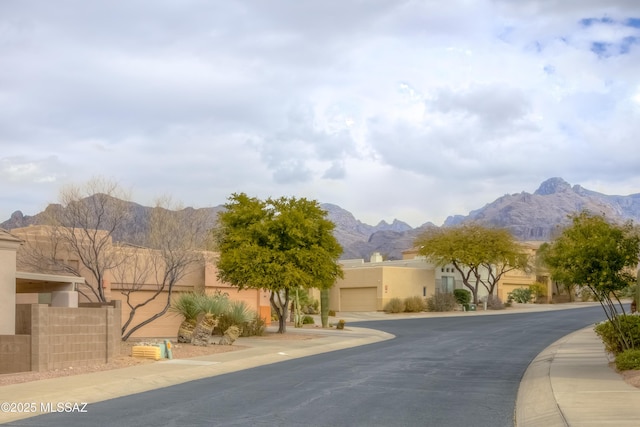 view of road featuring a mountain view and sidewalks