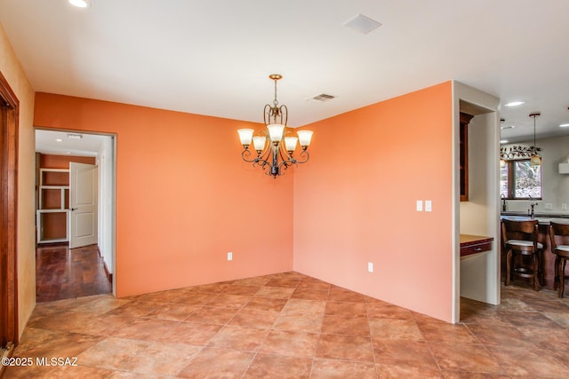 unfurnished room with a chandelier