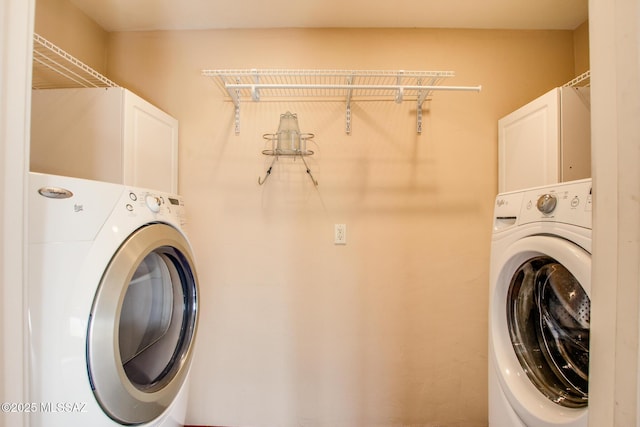 clothes washing area with cabinets and washer / clothes dryer