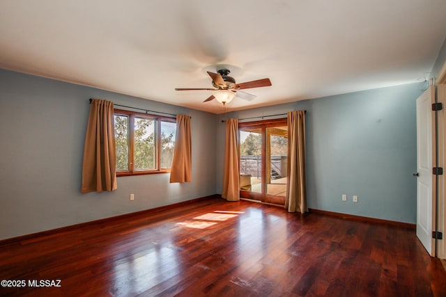 spare room featuring dark wood-type flooring and ceiling fan