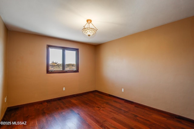 unfurnished room featuring dark hardwood / wood-style floors