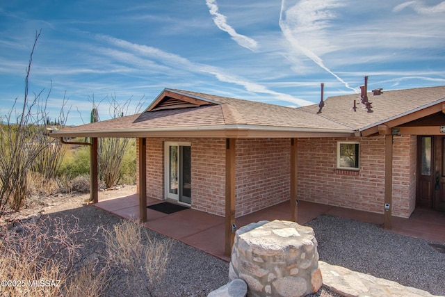 back of property with a patio