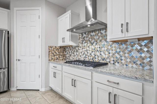 8270 W Spaulding St, Tucson, AZ 85743 - kitchen with wall chimney exhaust hood, stainless steel appliances, tasteful backsplash, white cabinets, and light stone counters