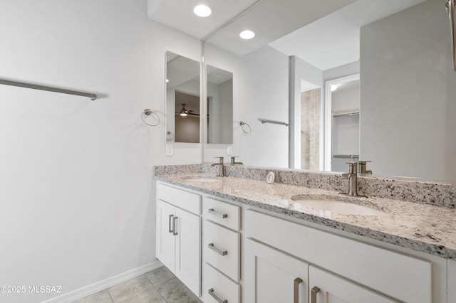 8270 W Spaulding St, Tucson, AZ 85743 - bathroom with double vanity, a ceiling fan, tile patterned flooring, baseboards, and recessed lighting