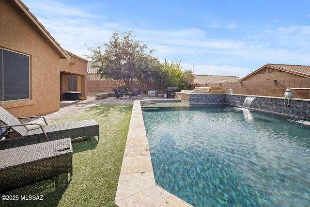 view of swimming pool featuring a yard, a patio area, and pool water feature