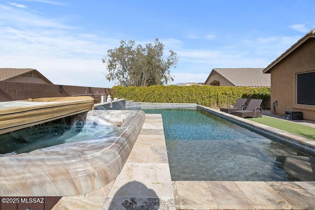 view of pool with a hot tub