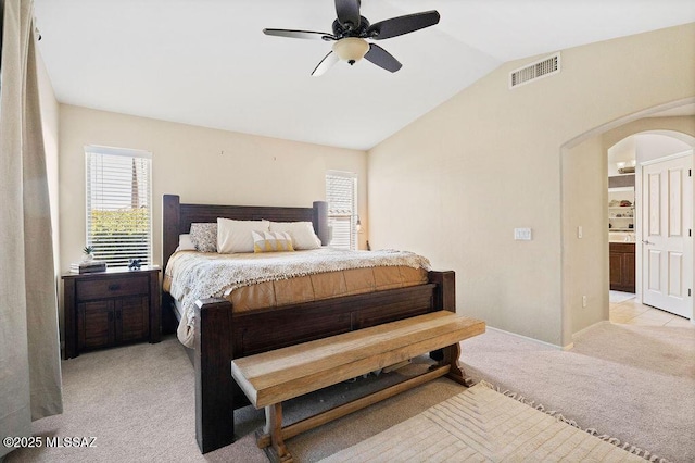 bedroom with light carpet, vaulted ceiling, and ceiling fan