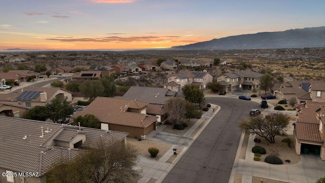 aerial view at dusk featuring a mountain view