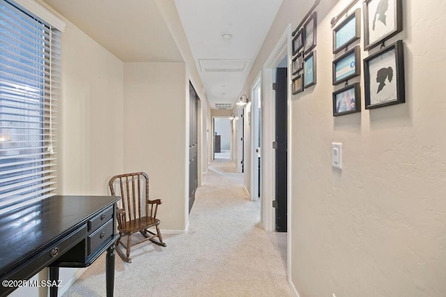 hallway featuring light colored carpet and plenty of natural light