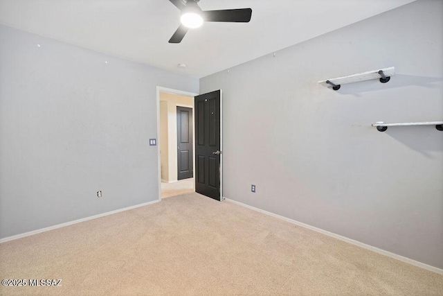 unfurnished bedroom with light colored carpet and ceiling fan