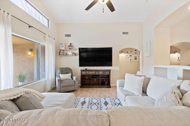 living room with ceiling fan and light wood-type flooring