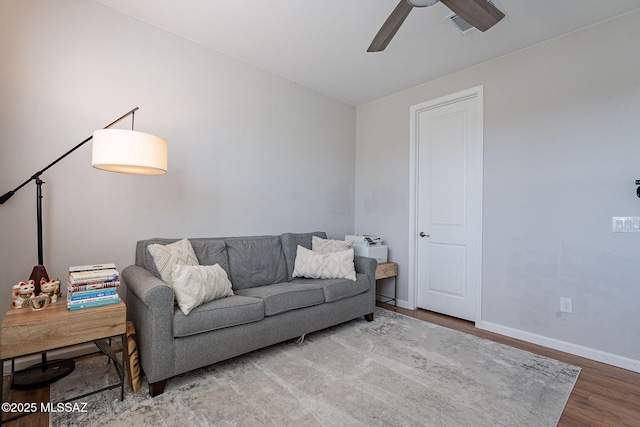 living room featuring hardwood / wood-style floors and ceiling fan