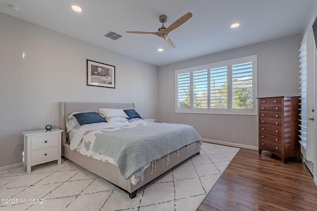 bedroom with ceiling fan and light hardwood / wood-style floors