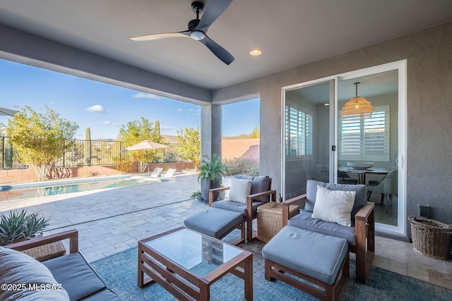 view of patio / terrace featuring ceiling fan and a fenced in pool