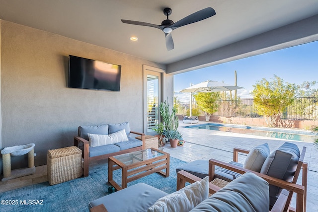 view of patio / terrace with ceiling fan, an outdoor living space, and a fenced in pool